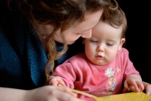mother reads to infant daughter