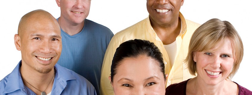 five adults smiling at viewer