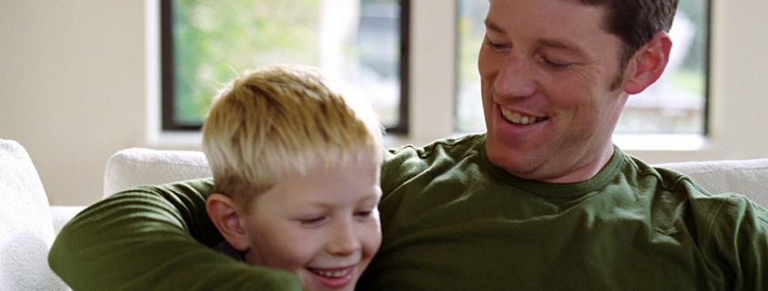 father and son share a laugh indoors