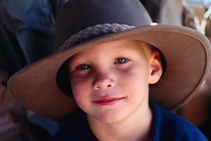 boy wears oversized cowboy hat