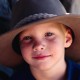 boy wears oversized cowboy hat