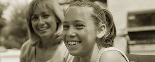 mother and teen daughter share a laugh