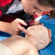 Practicing First Aid and CPR on infant dummy
