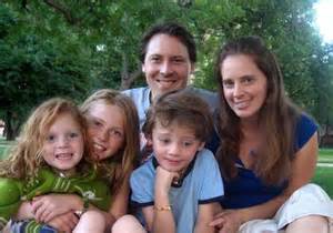 family of five sitting outdoors