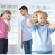 child covering ears while parents argue