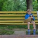 boy and stuffed toy dog sitting on a park bench