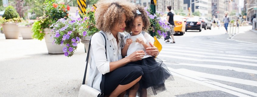 mother and daughter on the street in a city