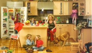 kids creating a mess in a kitchen with frazzled mom