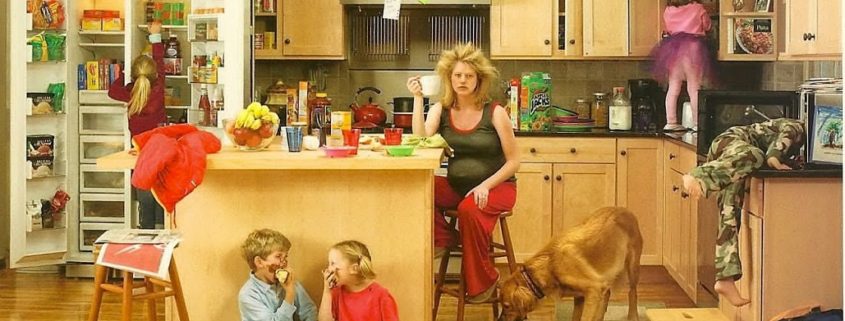 kids creating a mess in a kitchen with frazzled mom