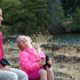 mother and daughter near water with binoculars