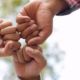 3 hands touching